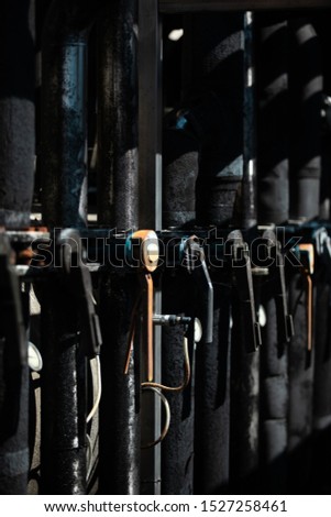alignment of dark valves in wine factory