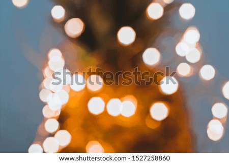 Blurred defocused fairy light glitter by Christmas lights on dark background, shallow DOF