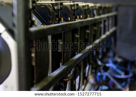 Video cards with on shelves connected to a farm for obtaining electronic money. Close-up. Out of focus. Blur