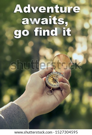 Compass in hand on natural background. Adventure Awaits, Go find it - motivation quote. concept of adventure, fees on road, vacation trip season. symbol of travel, journey. world tourism day