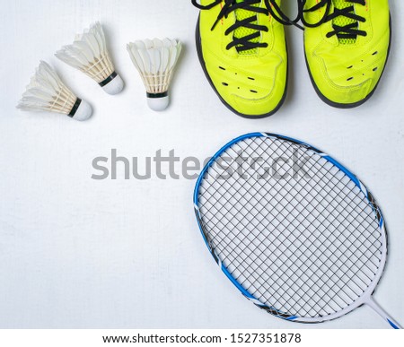Badminton competition equipment, Badminton racket, Badminton ball and shoes on white wood background