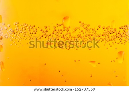 bubbles beer over yellow