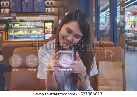 Customer Experience Concept, happy Business women holding the smartphone with a checked box on Excellent Face and Rating for a satisfaction survey.