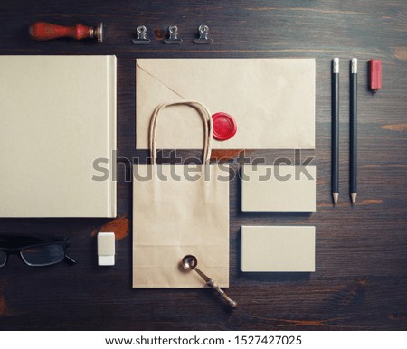 Kraft stationery set on wooden background. Blank corporate identity. Template for branding identity. Flat lay.