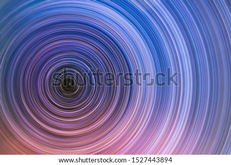 Beautiful starry sky with star trails orientation on the north star. Space background. Abstract long exposure background.