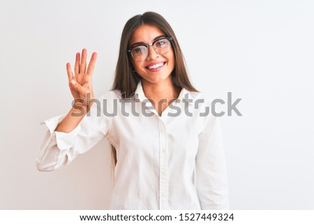 Young beautiful businesswoman wearing glasses standing over isolated white background showing and pointing up with fingers number four while smiling confident and happy.