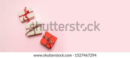 Minimal christmas newyear concept of Christmas red gift boxes, balls on pastel pink background.