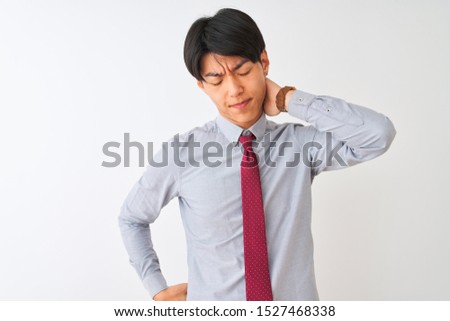 Chinese businessman wearing elegant tie standing over isolated white background Suffering of neck ache injury, touching neck with hand, muscular pain