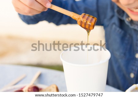 Kid Using Honey For Her Drink