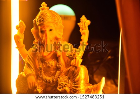 India - October 11, 2019: statue of holy Hindu God Ganesha, with a yellow light 