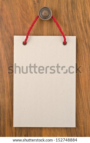 Paper signboard with rope hanging on a handle of door  
