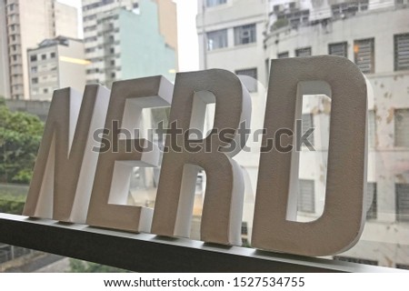 Nerd in white paper letters on a window