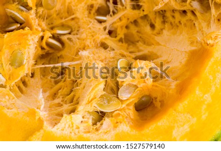 sliced and diced orange pumpkin on the kitchen table, close-up of raw vegetables before cooking