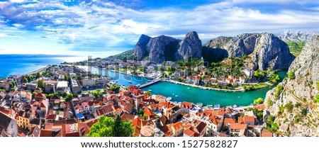 Landmarks of Croatia - impressive Omis town surrounded with gorge, over Cetina river. Popular tousrit destination Royalty-Free Stock Photo #1527582827