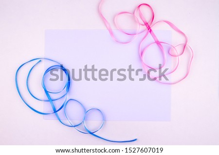 Pink and blue silk ribbons isolated on white background