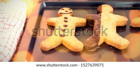 Composite image of brown parquet against christmas cookies in kitchen at home