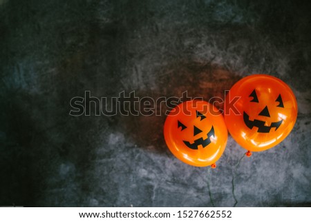 Orange pumpkin balloons for Halloween party on dark background. Happy Halloween. Holiday concept with colorful balloon.