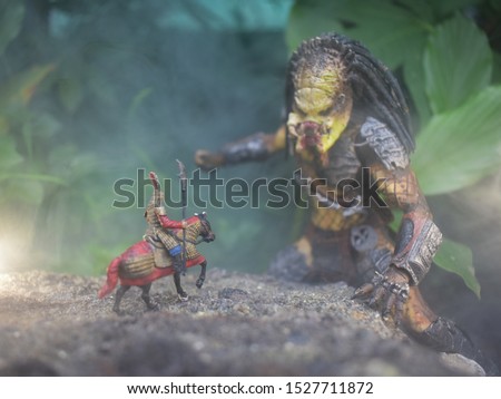 A photo of a battle between an ancient Chinese army and its horse, carrying a spear against a large Predator who is ready to pounce.

Photo concept toys, with smoke effects, create dramatic photos and