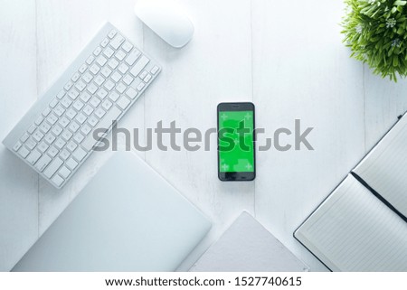 mock up office desk table with cup of coffe, smart phone, mouse, keyboard and supplies, isolated on white wooden table. Top view with copy space, white, clean, flat lay.