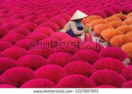Aerial view of Incense sticks drying outdoor with Vietnamese woman wearing conical hat in north of Vietnam. Royalty high quality free stock image from above