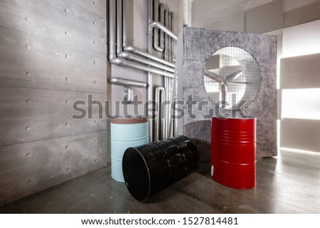 Interior photo Studio. Large metal barrels and concrete wall.
