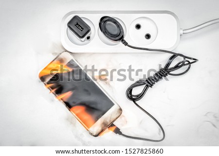 Phone is connected to power supply in case of fire, concept of fake power supply unit