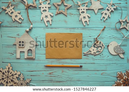 Christmas greeting card. Festive decoration on wood turquoise background. New Year concept. Copy space. Flat lay. Top view.