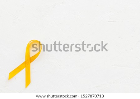Disease control concept. Yellow ribbon on white background top view copy space