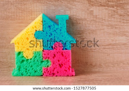 House in different colors on a wooden background. Concept purchase, rent of housing. The symbol of the home. Construction of  building. Concept Construction of housing. Copyspace