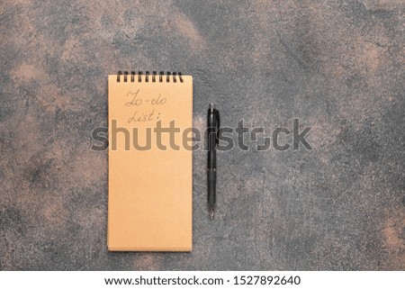 Empty to do list and pen on grunge background