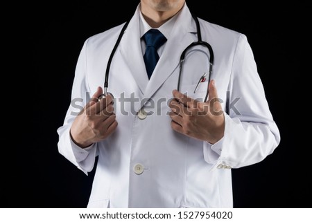Doctor in lab coat on black background
