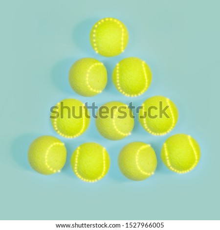 sport, fitness, game and objects concept - Christmas and New year concept with tennis balls top view. Illuminated Christmas tree shape
