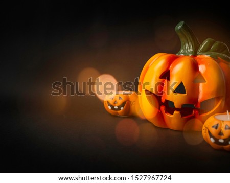 
Halloween pumpkins, candles, decorations, party. Black background, place for text.