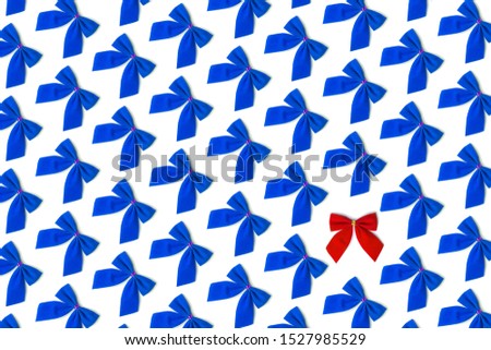 Blue bows, one red on white background, Christmas pattern, not like everything, unique, against the system.