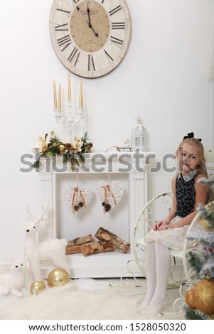A portrait of a beautiful blonde girl. Christmas time.
