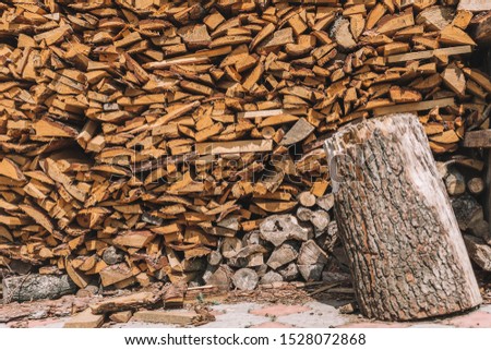 stacks of firewood. firewood for the winter, 
dry chopped pile of firewood. wall of fire wood background.