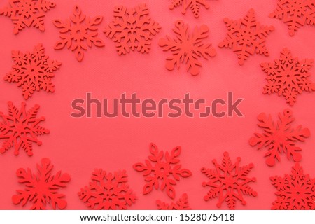 Christmas composition, red snowflakes on red background. Flat lay, top view, copy space