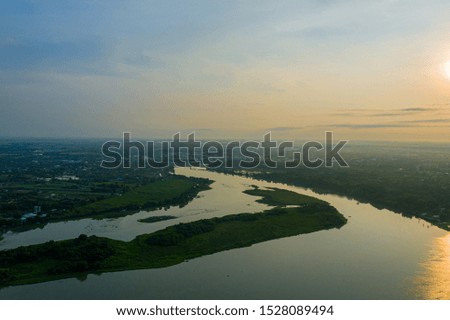 Aerial landscape of in Kanchanaburi province, Thailand. Image consist of rice field, mountain and blue sky with cloud.