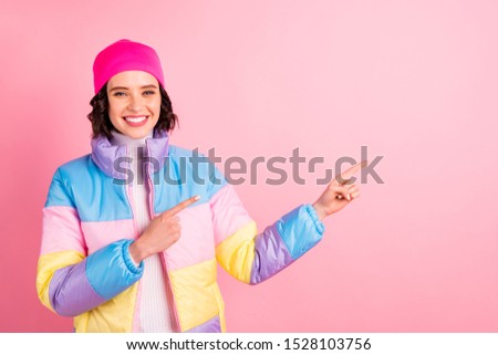 Closeup photo of nice lady indicating hands empty space wear warm colored coat isolated pink background