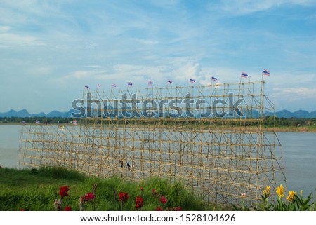 Large advertising signs made of bamboo,Nakhon Phanom steamer flow,Bamboo scaffolding on a boat for religious ceremonies.