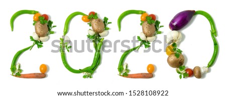 Number 2020 written with vegetables, as a metaphor or concept for healthy food, living, diet, recipe. Isolated on white background. Happy new year. End of the year resolution Royalty-Free Stock Photo #1528108922