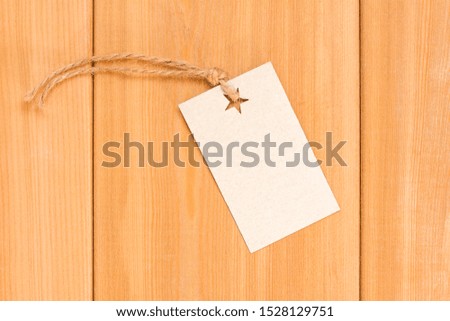 Retro cardboard Label on wood mockup. Blank tag with rope. Empty organic style sticker. Flat lay
