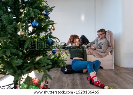 The guy with the girl celebrate the new year. Young couple celebrates christmas.