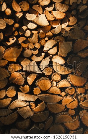 Wall firewood , Background of dry chopped firewood logs in a pile. Harvesting firewood for the winter. Harvesting firewood for the winter. Heating season, eco-raw materials