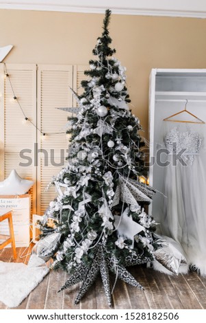 New Year 2021 mood, Christmas tree. Cozy room with fireplace, wardrobe and candlesticks. Merry Christmas.