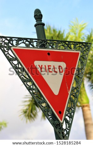 Interesting framed yield sign with tropical background