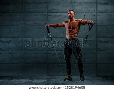 Muscular Athletic Men Exercise With Resistance Band. Copy Space Royalty-Free Stock Photo #1528194608