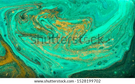 Green and gold marbling pattern. Golden powder marble liquid texture. Royalty-Free Stock Photo #1528199702