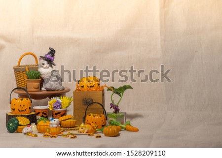 halloween holiday decoration concept, A lot of halloween party object miniature toys decoration on wrinkled calico background.