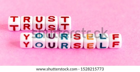 Quote "Trust yourself" made out of colorful beads
